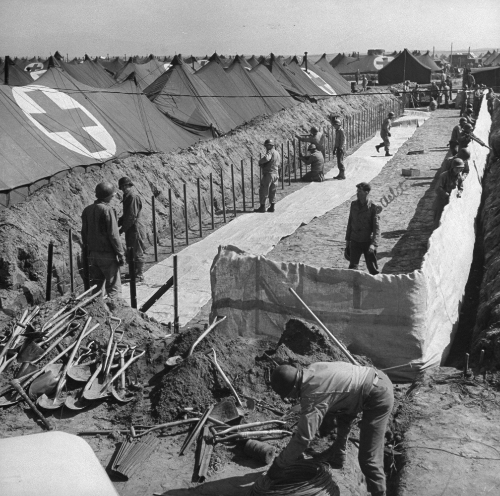 American hospital ward tents being erected below ground level for protection from enemy shelling, Anzio, 1944.