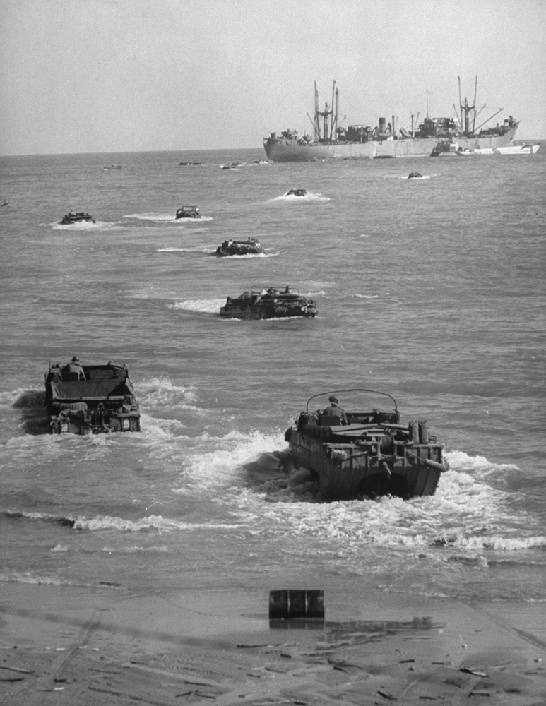Amphibious trucks ferry supplies from cargo ship to Anzio beach. A few minutes before, a number of them had been sunk in attack by German fighter-bombers.