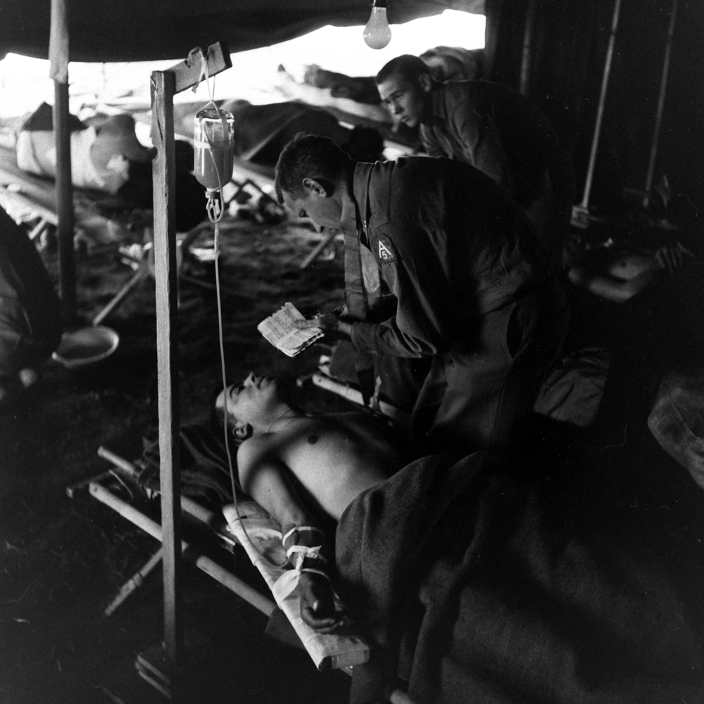 Wounded soldier and chaplain, Anzio, 1944.