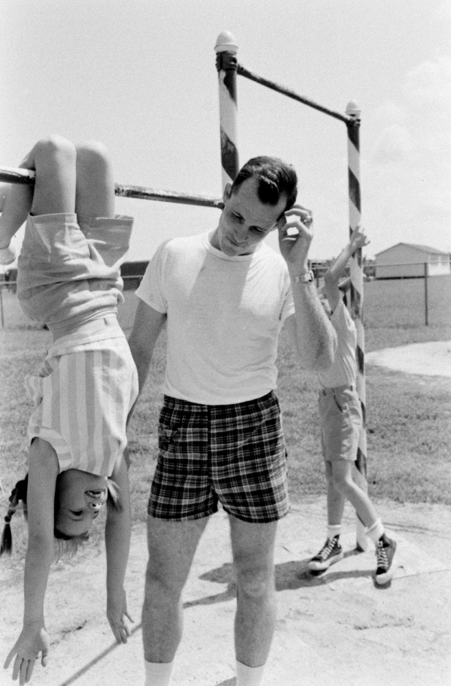 During a family work-out on the horizontal bar, Bonnie Lynn and Eddie White compete against their father, astronaut Ed White.