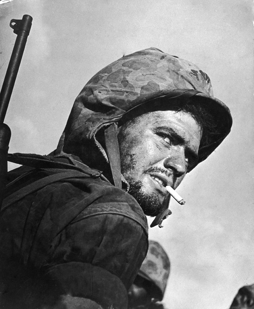 A U.S. Marine peers over his shoulder during the final days of fighting to wrest the island of Saipan from Japanese troops, 1944.