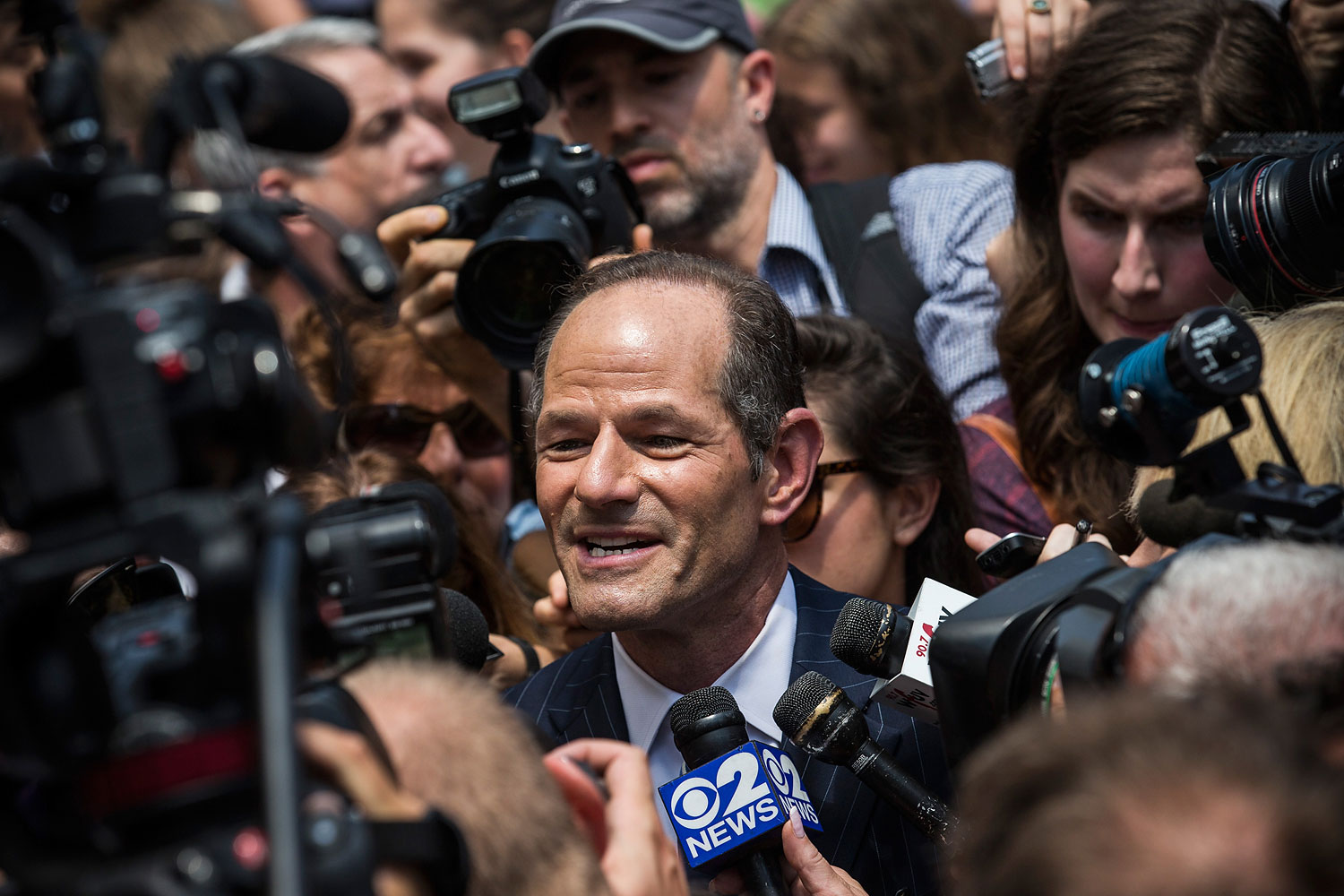 Former New York Gov. Eliot Spitzer is mobbed by reporters while attempting to collect signatures to run for comptroller of New York City on July 8, 2013 in New York City.