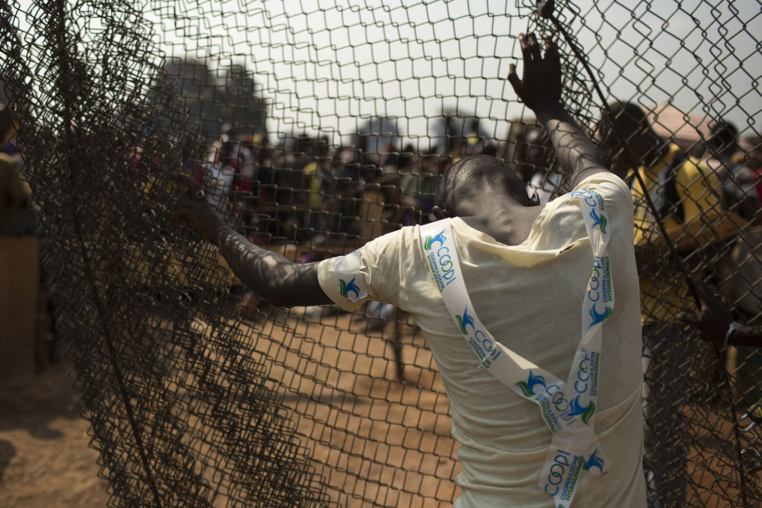 Jan. 21, 2014. A man stands by a fence at the edge of a camp for internally displaced persons (IDPs) at the airport of the capital Bangui, Central african Republic.