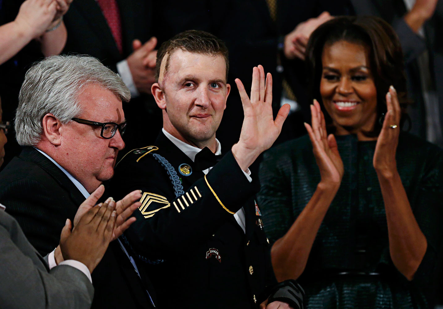 First lady Michelle Obama applauds U.S. Army Ranger Sgt. First Class Cory Remsburg, injured while serving in Afghanistan, during President Barack Obama's State of the Union speech on Capitol Hill in Washington, Jan. 28, 2014. (Gary Cameron / Reuters)