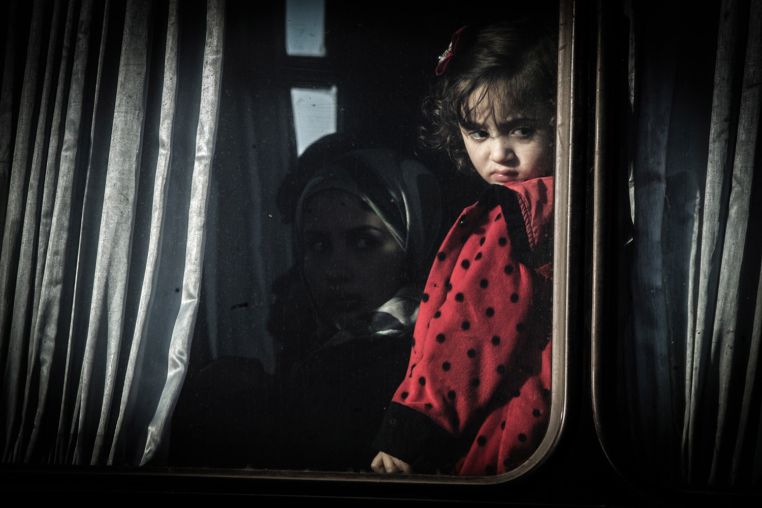 Jan. 21, 2014. A Palestinian girl looks out a bus window as she waits with her family, hoping to cross into Egypt, at the Rafah crossing between Egypt and the southern Gaza Strip.