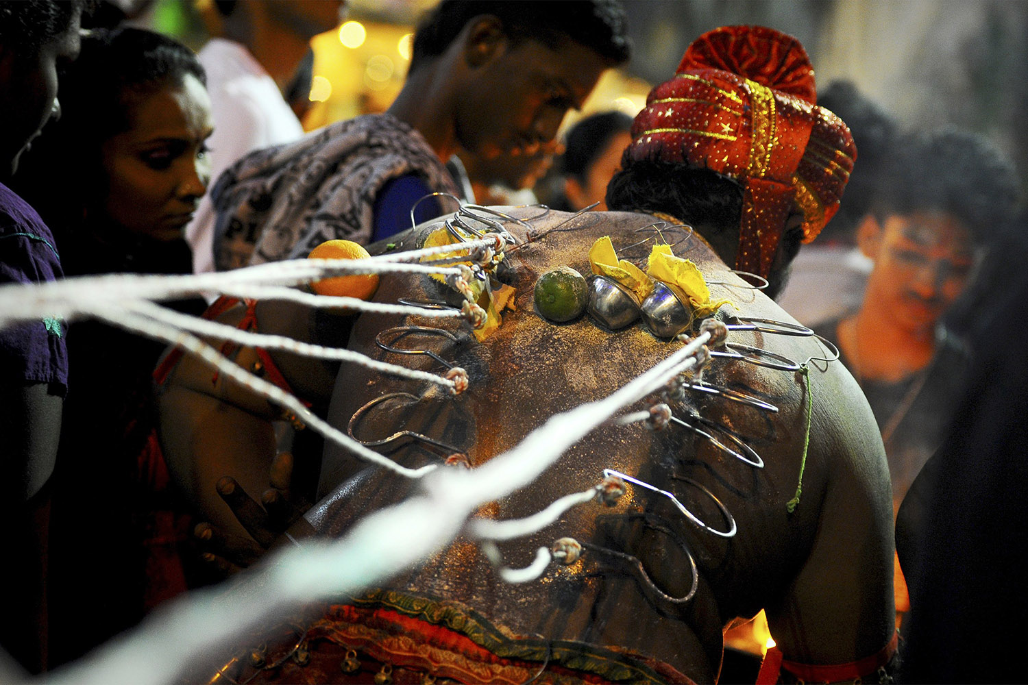Jan. 17, 2014. A Hindu devotee having hooks embedded in his back prepares for his pilgrimage climb up the stairs of Batu Caves temple during the Thaipusam festival in Kuala Lumpur, Malaysia.