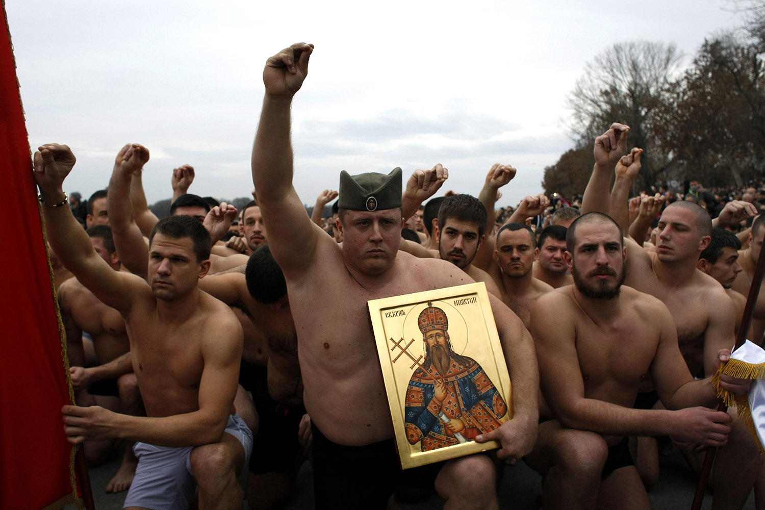 Jan. 19, 2014. Orthodox Christian believers kneel in prayer before a traditional cross retrieval race,  in Belgrade, Serbia.
