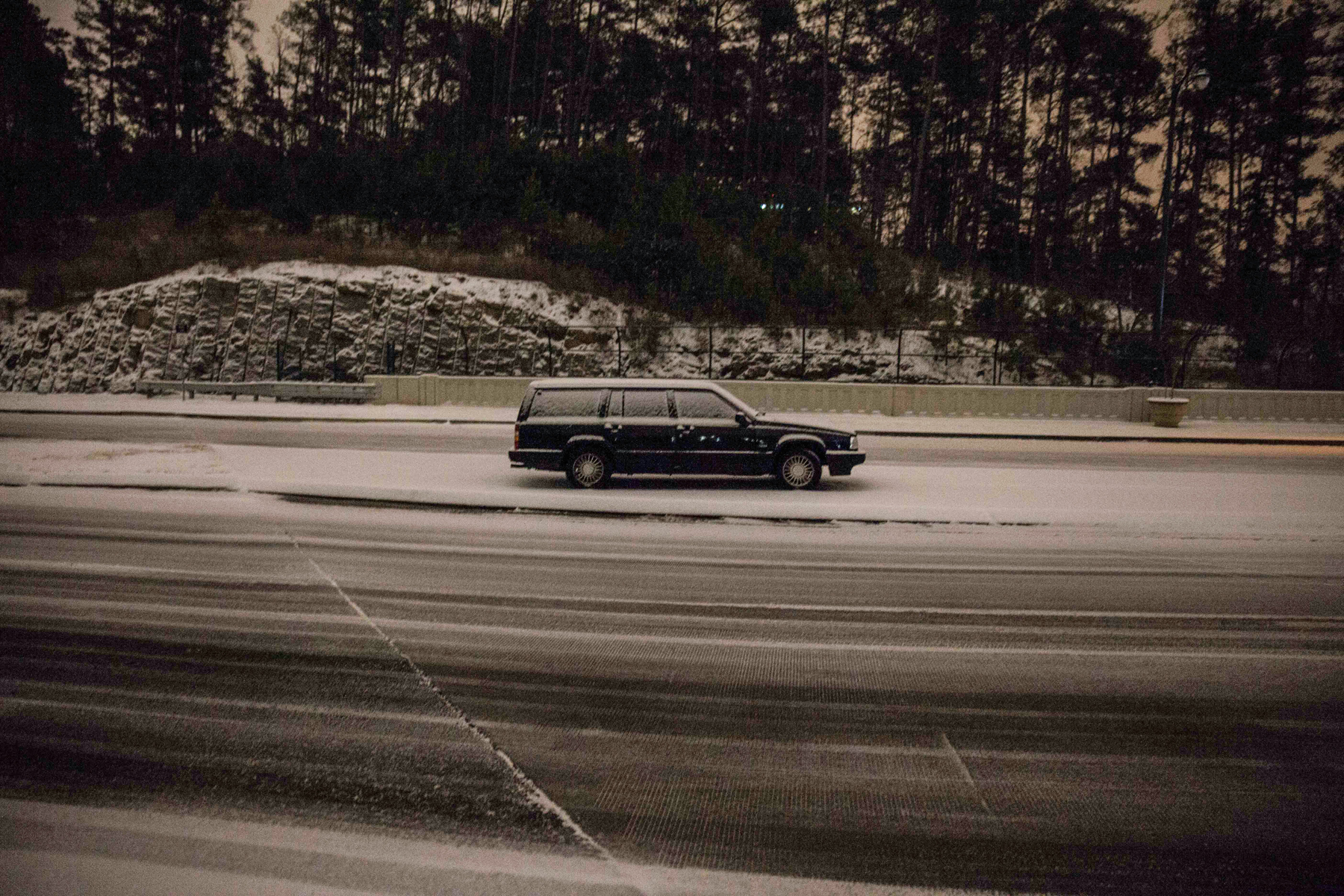 A car sits abandoned on Peachtree Center Parkway, Tuesday evening, Jan. 28, 2014, in Dunwoody, Ga.
