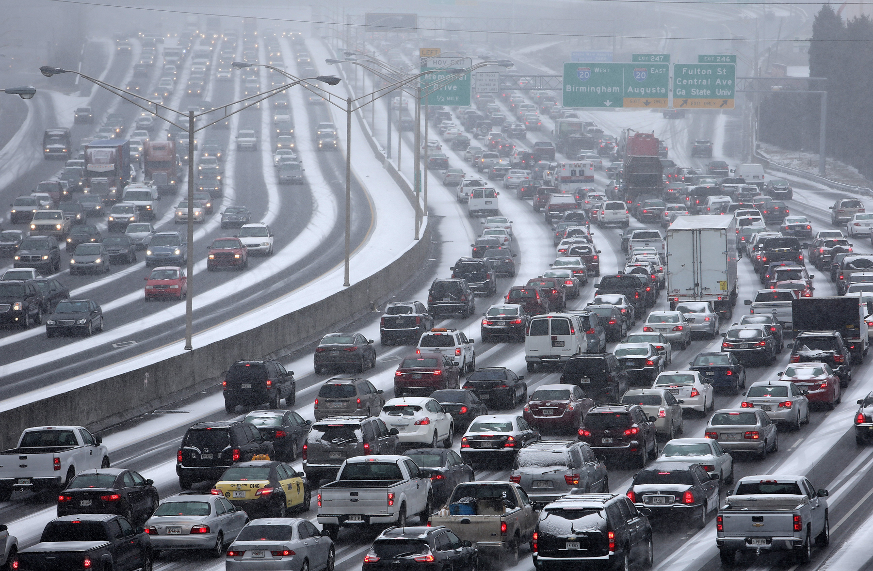 Traffic inches along the Connector as snow blankets the Metro on Tuesday afternoon Jan. 28, 2014.