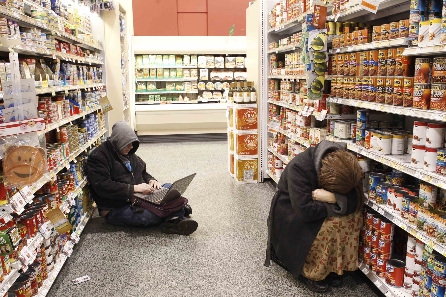 People rest at aisle of a Publix grocery store after being stranded due to a snow storm in Atlanta