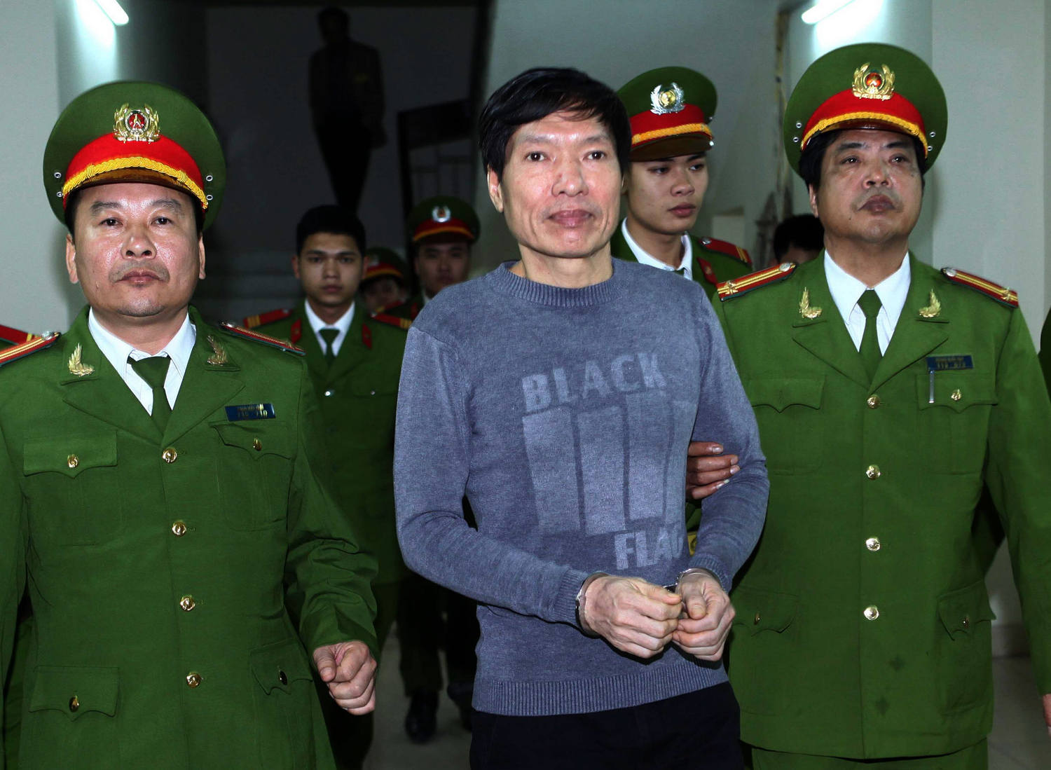 Former police Colonel Duong Tu Trong (C) is led away from the courtroom after he was sentenced to 18 years in jail by Hanoi's People's Court on January 8, 2014. (AFP/Getty Images)