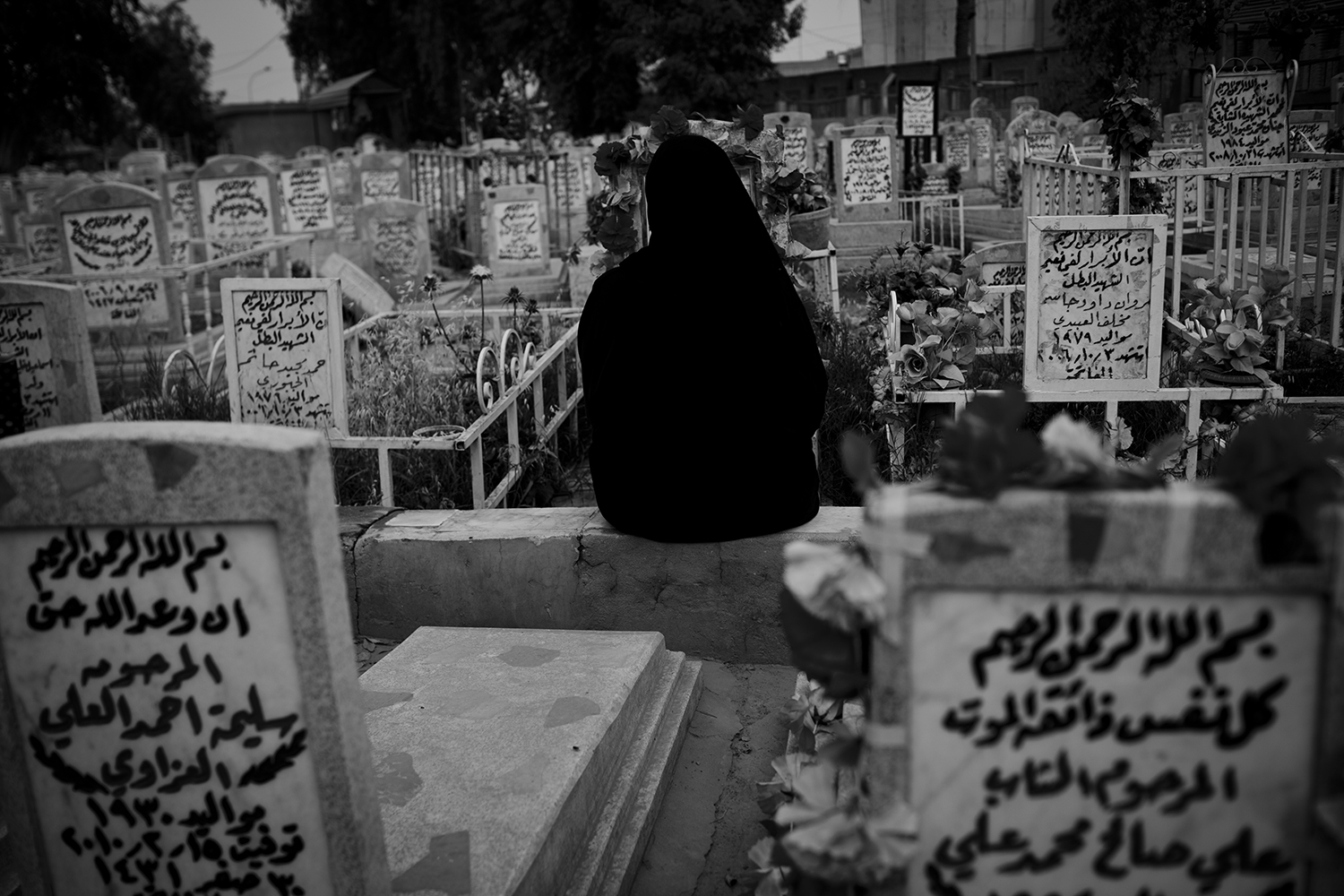 Apr. 18, 2012. Baghdad. A woman prays at the cemetery for her dead son.