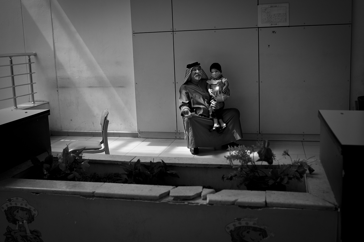 Apr. 23, 2012. Basra. An old man prays for his grandson, who suffers from leukemia, inside the Children's Hospital.