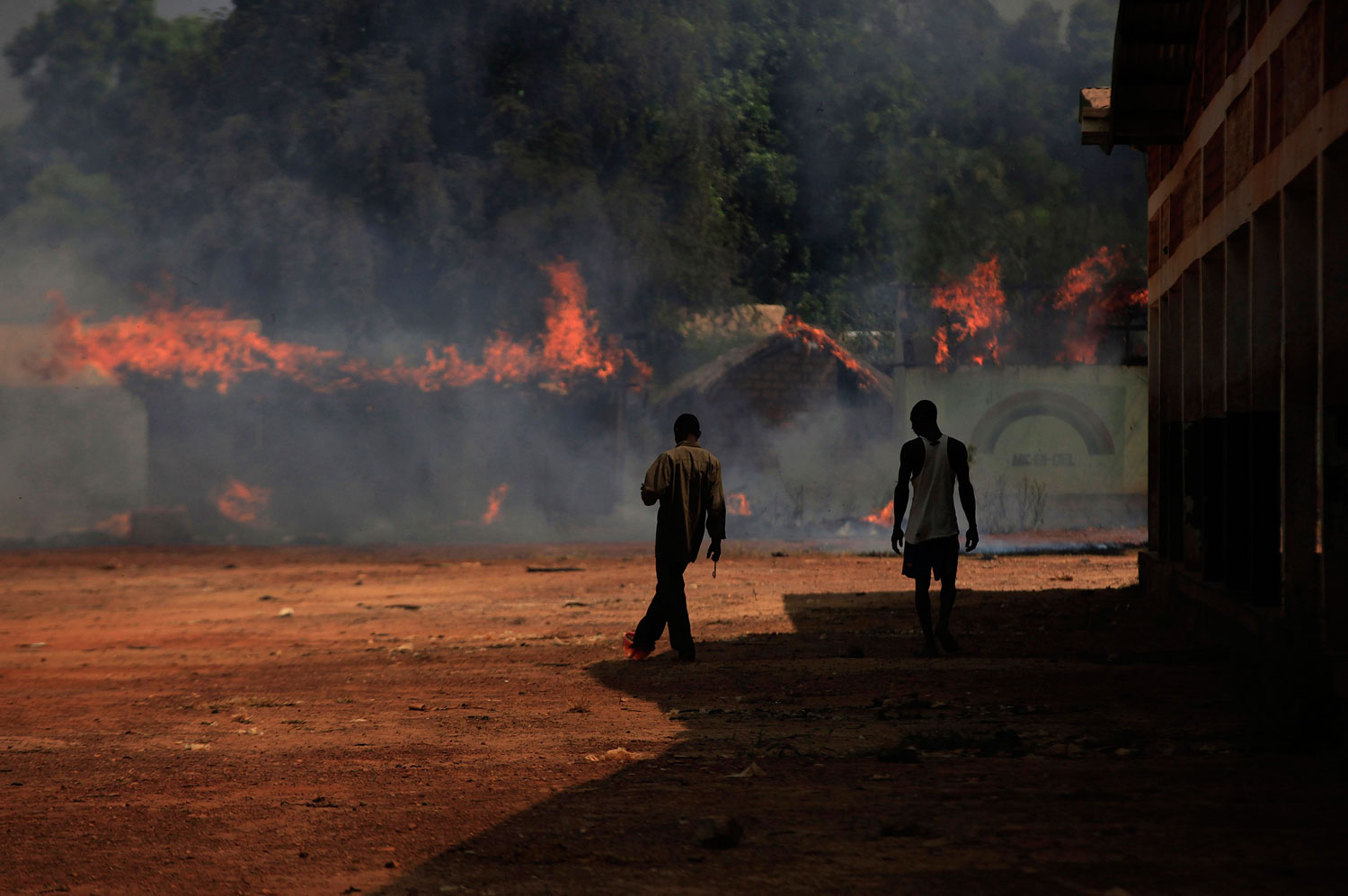 Youths walk towards burning houses in Bossangoa, north of Bangui, Jan. 2, 2014.