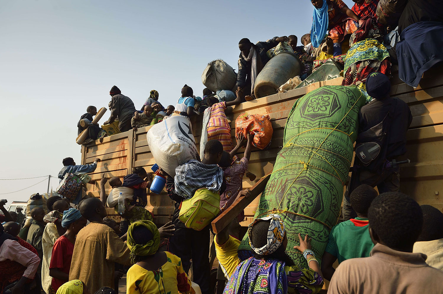 Chadian civilians climb on a military chadian truck to go back to Chad on Jan. 15, 2014 in the PK12 district of Bangui.