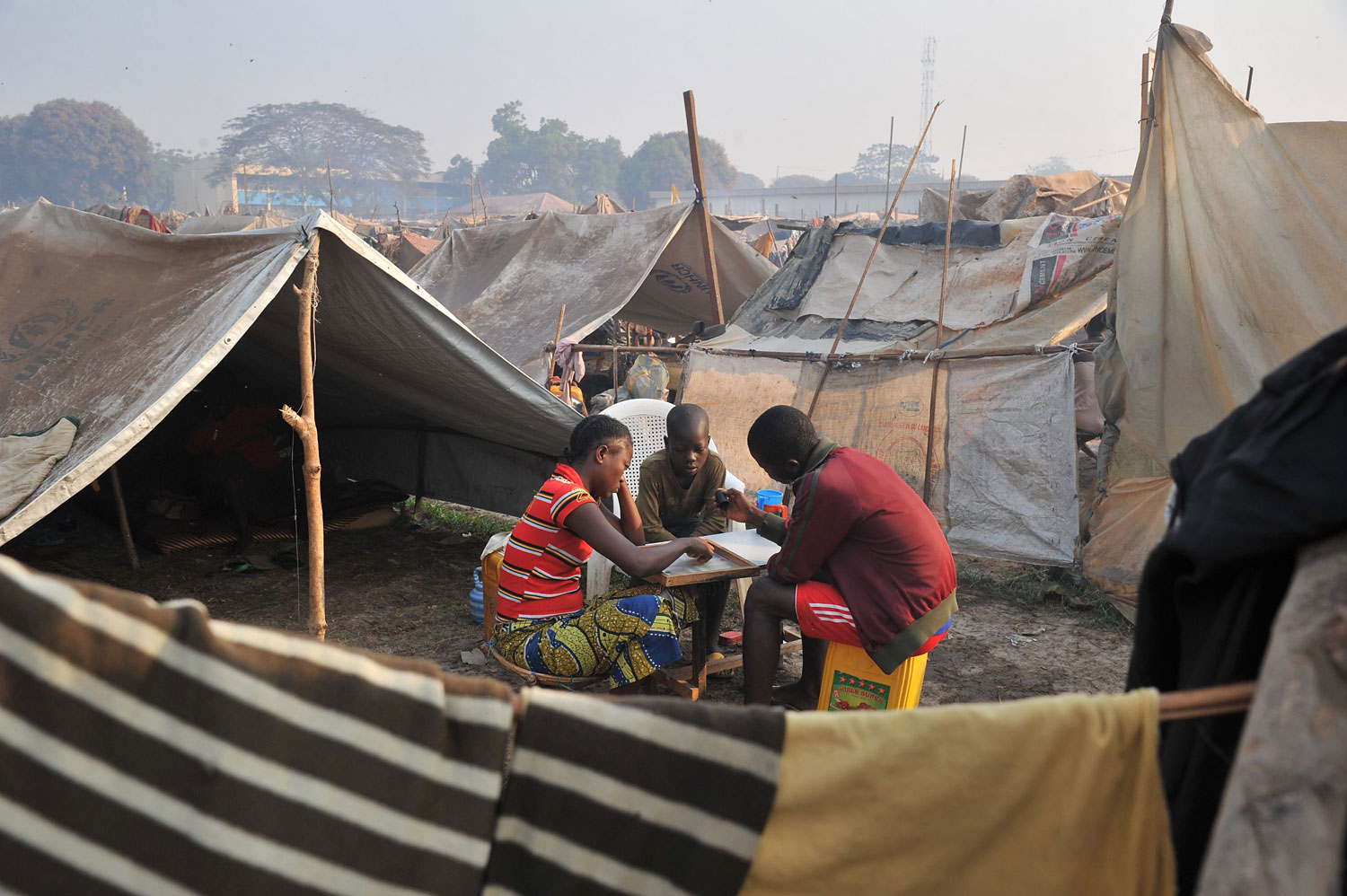 Children play next to makeshift shelters in the camp for displaced persons near the Mpoko airport in Bangui, on Jan. 21, 2014, a day after the election of Catherine Samba-Panza as the new President of the Central African Republic.