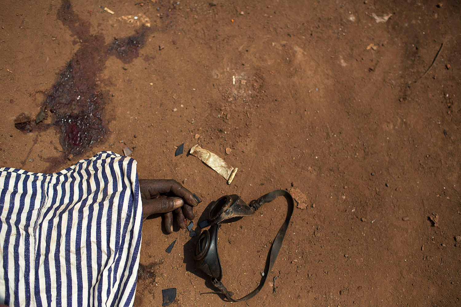 The dead body of a man killed during one of the latest incidents of sectarian violence is pictured on the ground in the district of Combattant near the airport of the capital Bangui, Jan. 29, 2014.