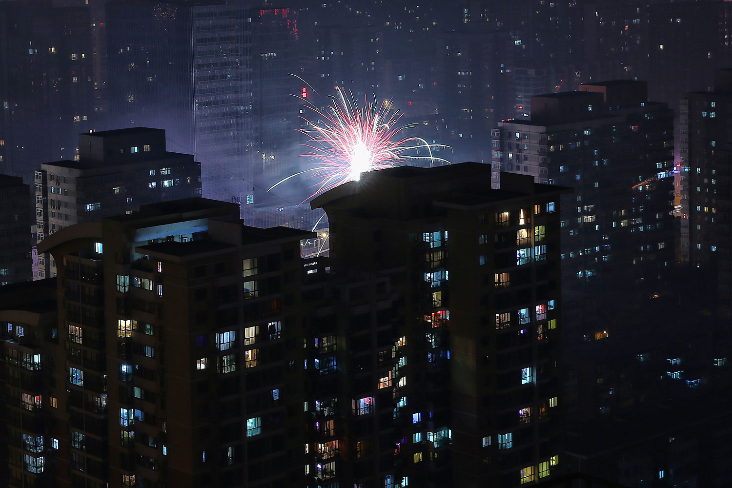 Fireworks illuminate a residential area to celebrate Chinese Lunar New Year of Horse and cause severe air pollution on Jan. 30, 2014 in Beijing.