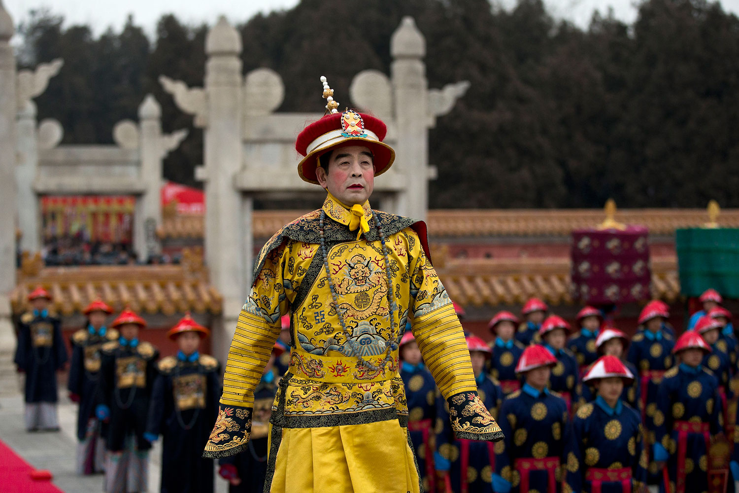 A man dressed as a Qing Dynasty emperor performs in a reenactment of an imperial ritual ceremony praying for good harvest in the coming year at the Temple of Earth park on the Spring Festival in Beijing Jan. 31, 2014.