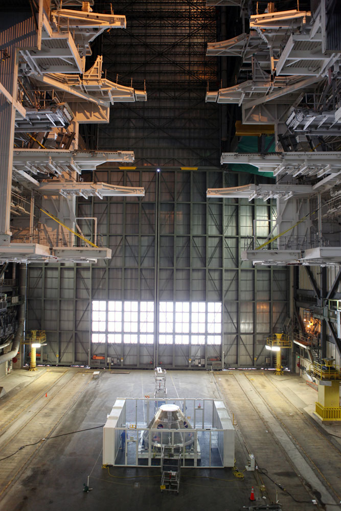 The vast expanse of High Bay 3 in the Vehicle Assembly Building dwarfs the Orion capsule and clean room, on May 24, 2012. The clean room is designed to keep particles inside the VAB from collecting on the outside of the spacecraft during processing.