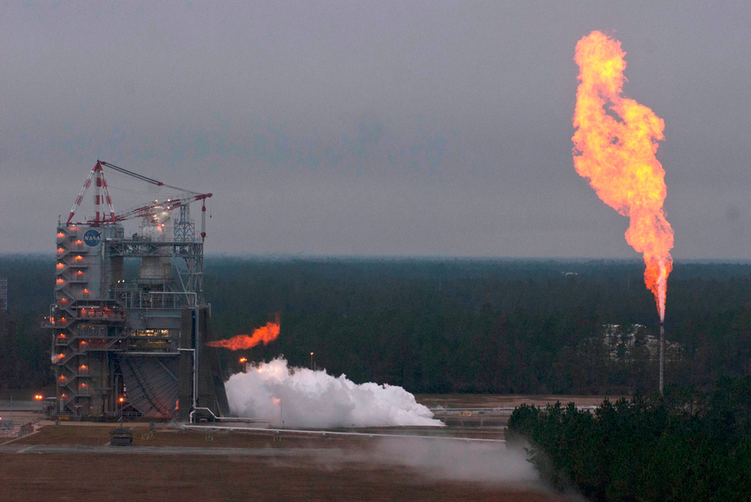 A version of the J-2X engine burns brightly during a 278-sec. hot fire test Nov. 27, 2012 at NASA's Stennis Space Center in Mississippi. The J-2X will power the upper stage of of the SLS.