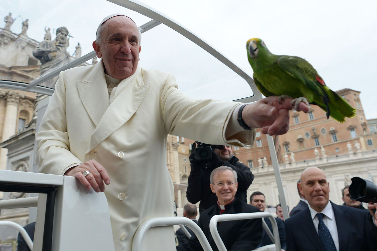 Pope Francis holds a parrot shown by a pilgrim as he arrives for his general audience at St Peter's square on January 29, 2014 at the Vatican. (Osservatore Romano—AFP—Getty Images)