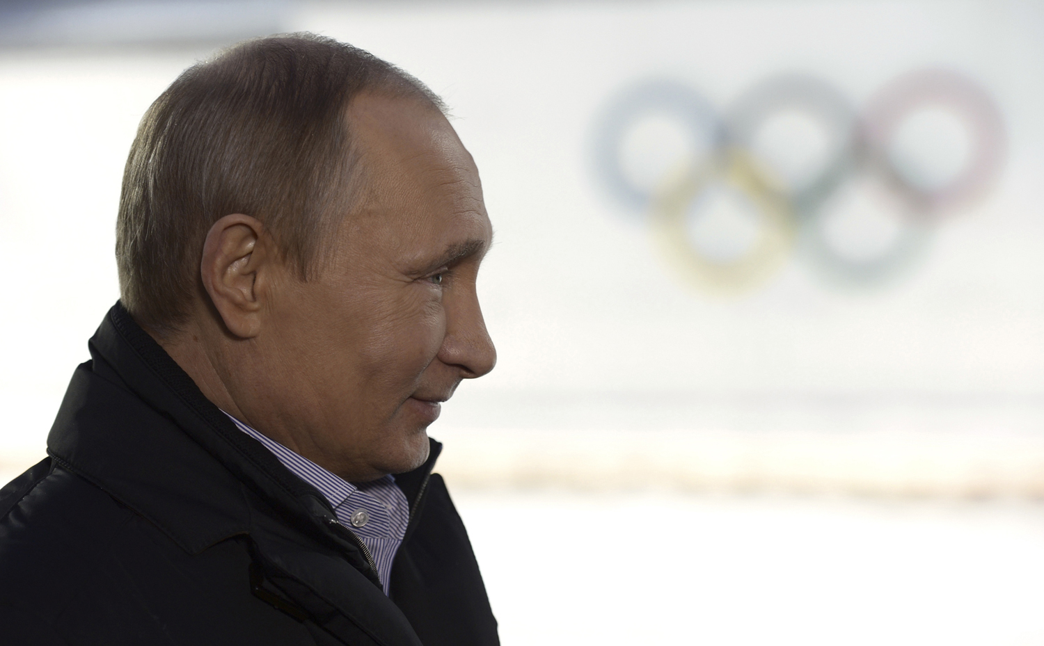 Russian President Putin listens to a journalist's question during a televised news conference in Sochi