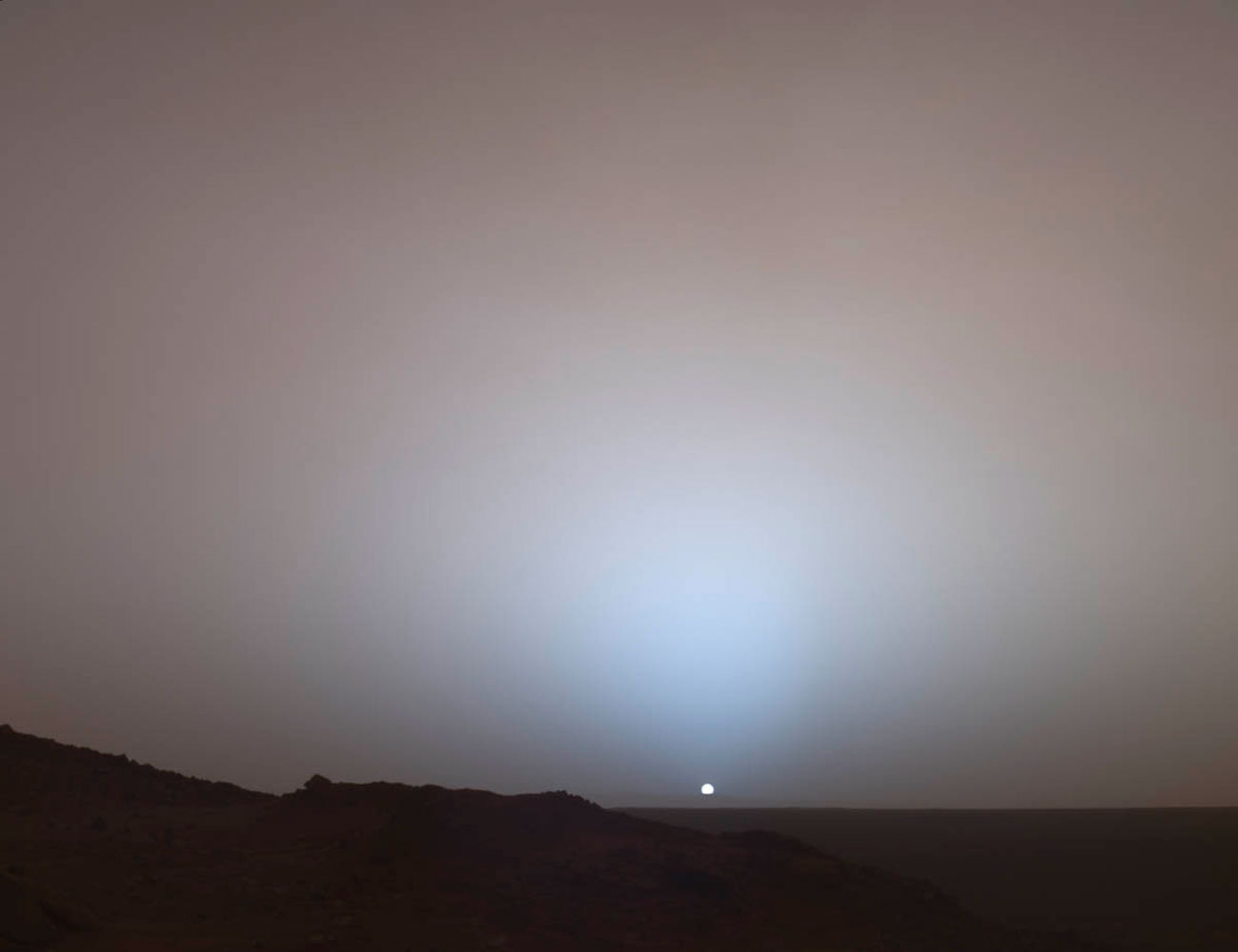 The Mars Rover Spirit took this sublime view of a sunset over the rim of Gusev Crater, about 80 kilometers (50 miles) away.