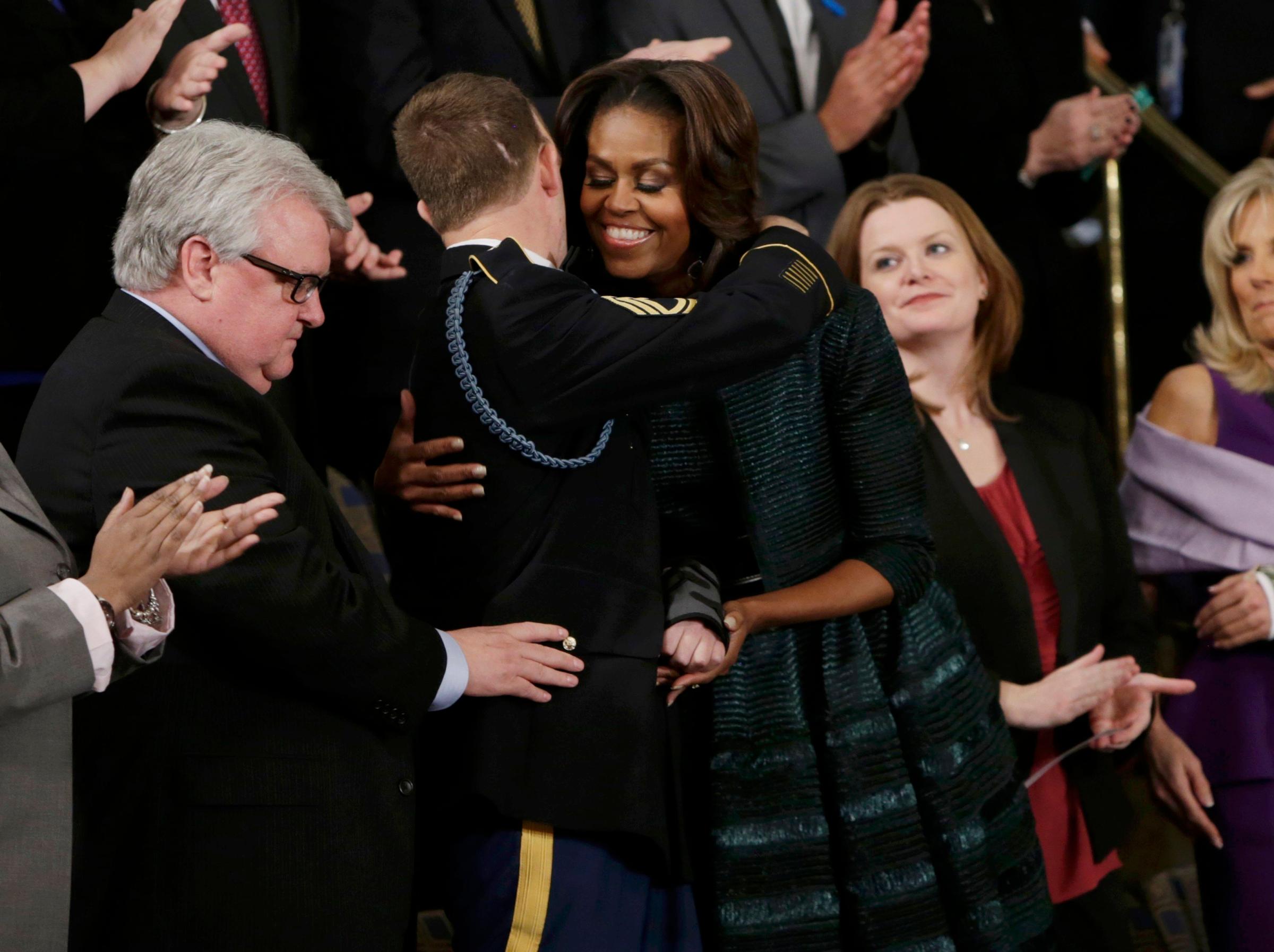 First Lady Michelle Obama hugs U.S. Army Ranger Sgt. First Class Cory Remsburg, who was injured while serving in Afghanistan.