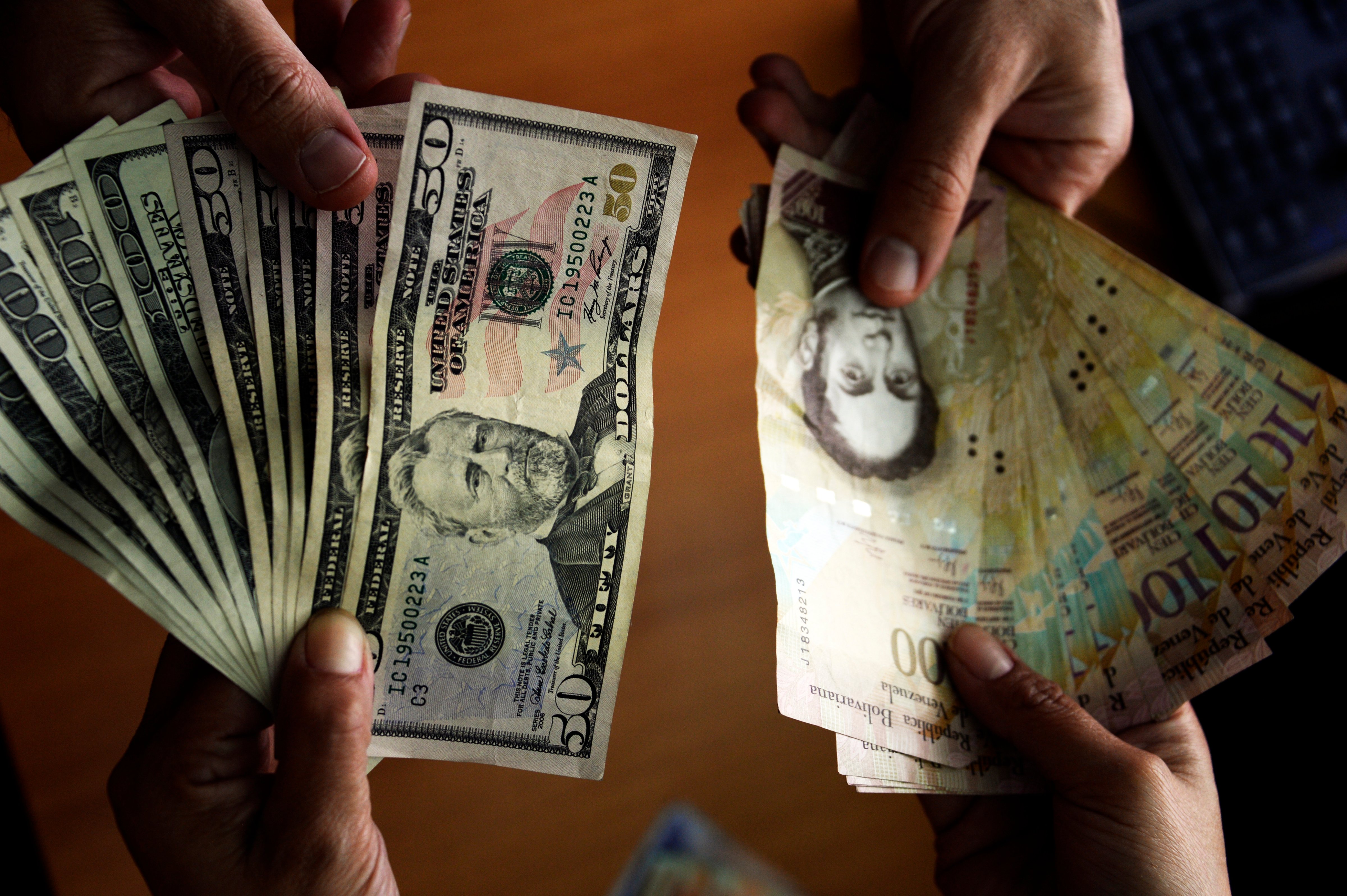 U.S. dollars and Venezuelan Bolivares in Caracas on July 16, 2013. (Juan Barreto / AFP / Getty Images)