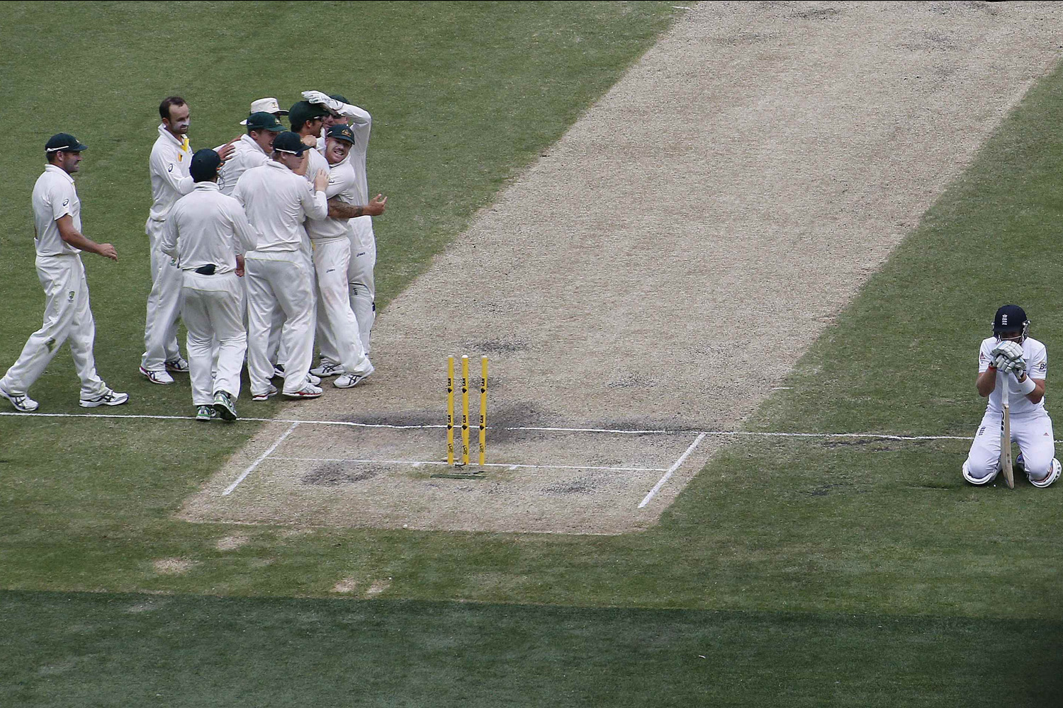 Australia's team celebrates after the dismissal of England's Root during the third day of the fourth Ashes cricket test at the Melbourne cricket ground