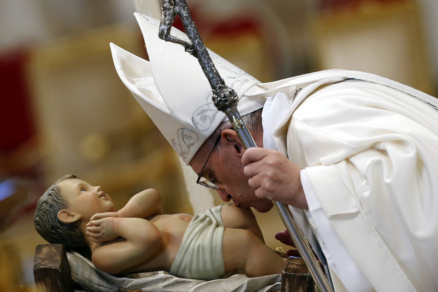 Jan. 1, 2014. Pope Francis kisses a baby Jesus statue as he leads a mass at Saint Peter's Basilica at the Vatican, Italy.