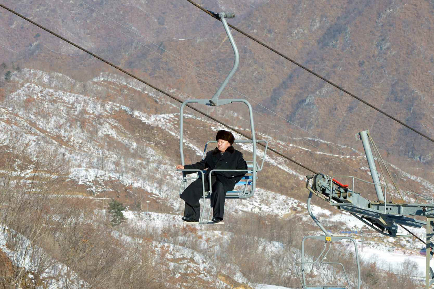 North Korean leader Kim Jong Un sits on a ski lift during a visit to a newly built ski resort in the Masik Pass region
