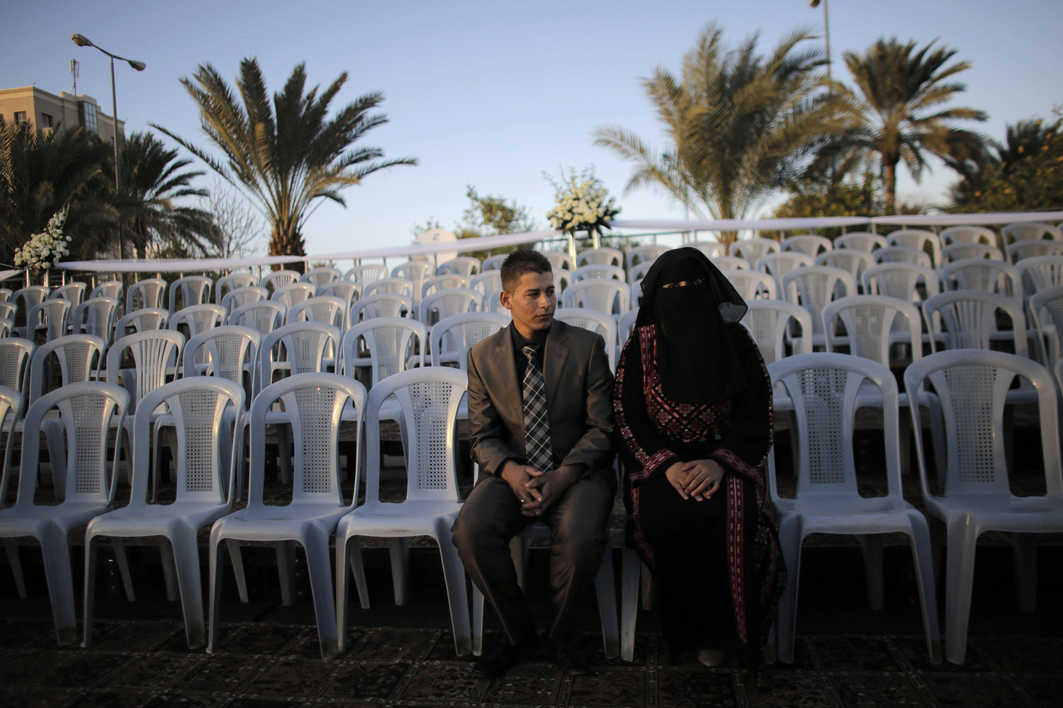 A Palestinian couple waits before a mass wedding ceremony in the West Bank city of Jericho