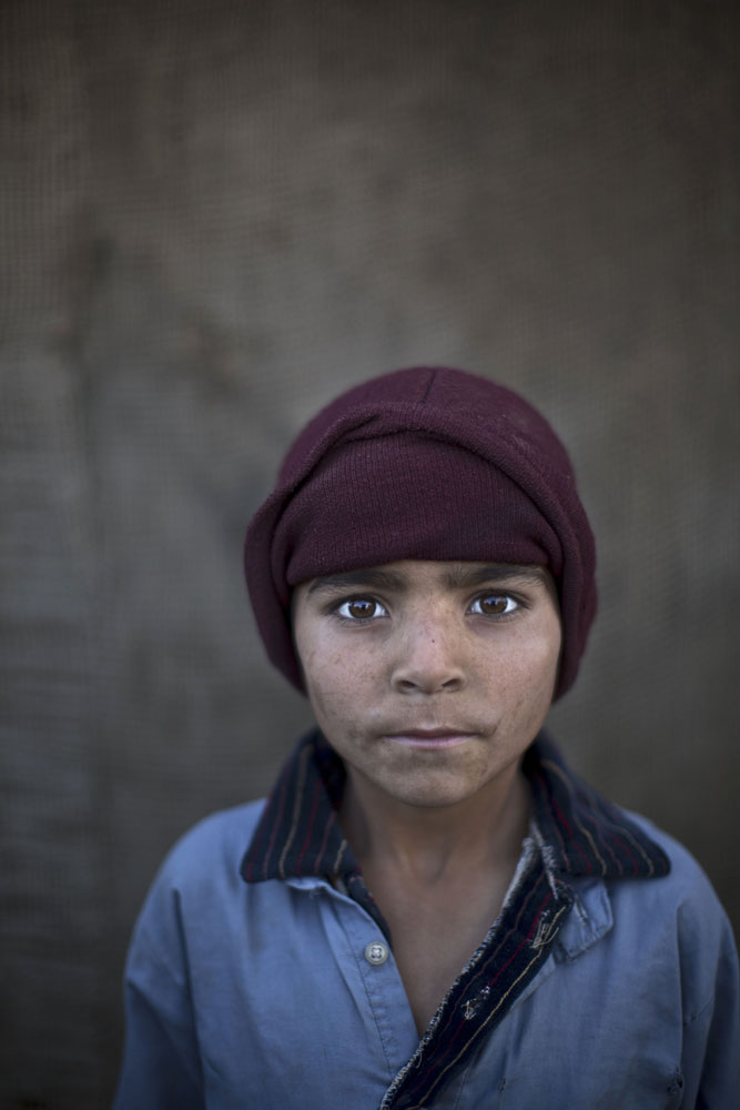 Noorkhan Zahir, 6, poses for a picture, while playing with other children in a slum on the outskirts of Islamabad, Pakistan on Jan. 26, 2014.