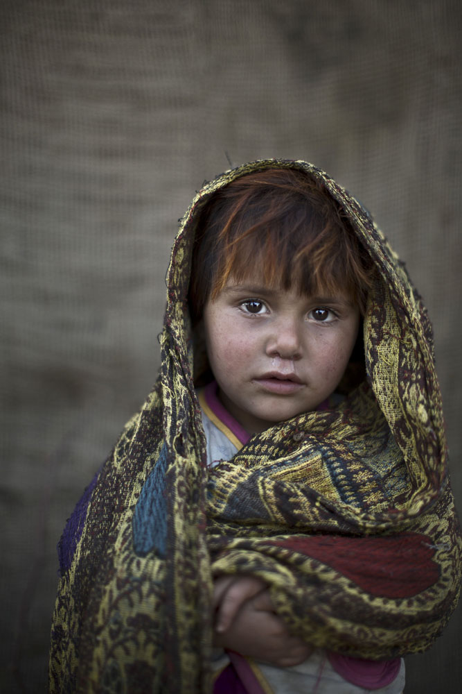 Safia Mourad, 4, poses for a picture while playing with other children in a slum on the outskirts of Islamabad, Pakistan on Jan. 24, 2014.