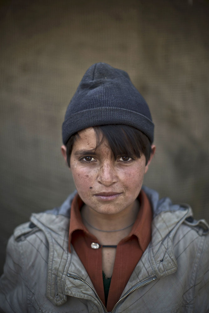 Abdulrahman Bahadir, 13, poses for a picture in a slum on the outskirts of Islamabad, Pakistan on Jan. 25, 2014.