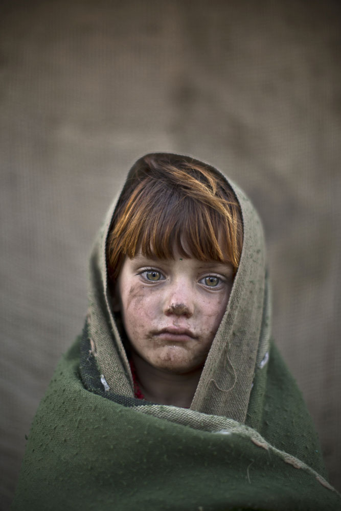 Laiba Hazrat, 6, poses for a picture while playing with other children in a slum on the outskirts of Islamabad, Pakistan on Jan. 24, 2014.