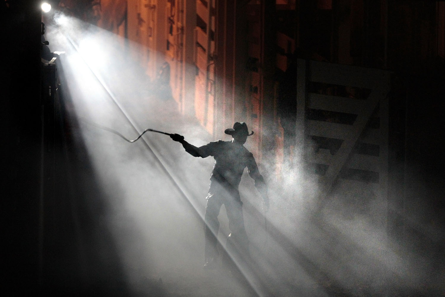 Jan. 22, 2014. A cowboy with a whip walks through a mist into the arena during the opening of Bulls' Night Out  at the Fort Worth Stock Show and Rodeo in Fort Worth, Texas.