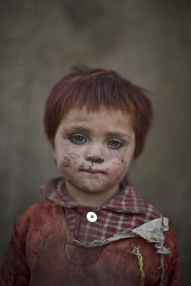 Gul Bibi Shamra, 3, poses for a picture while playing with other children in a slum on the outskirts of Islamabad, Pakistan on Jan. 24, 2014.