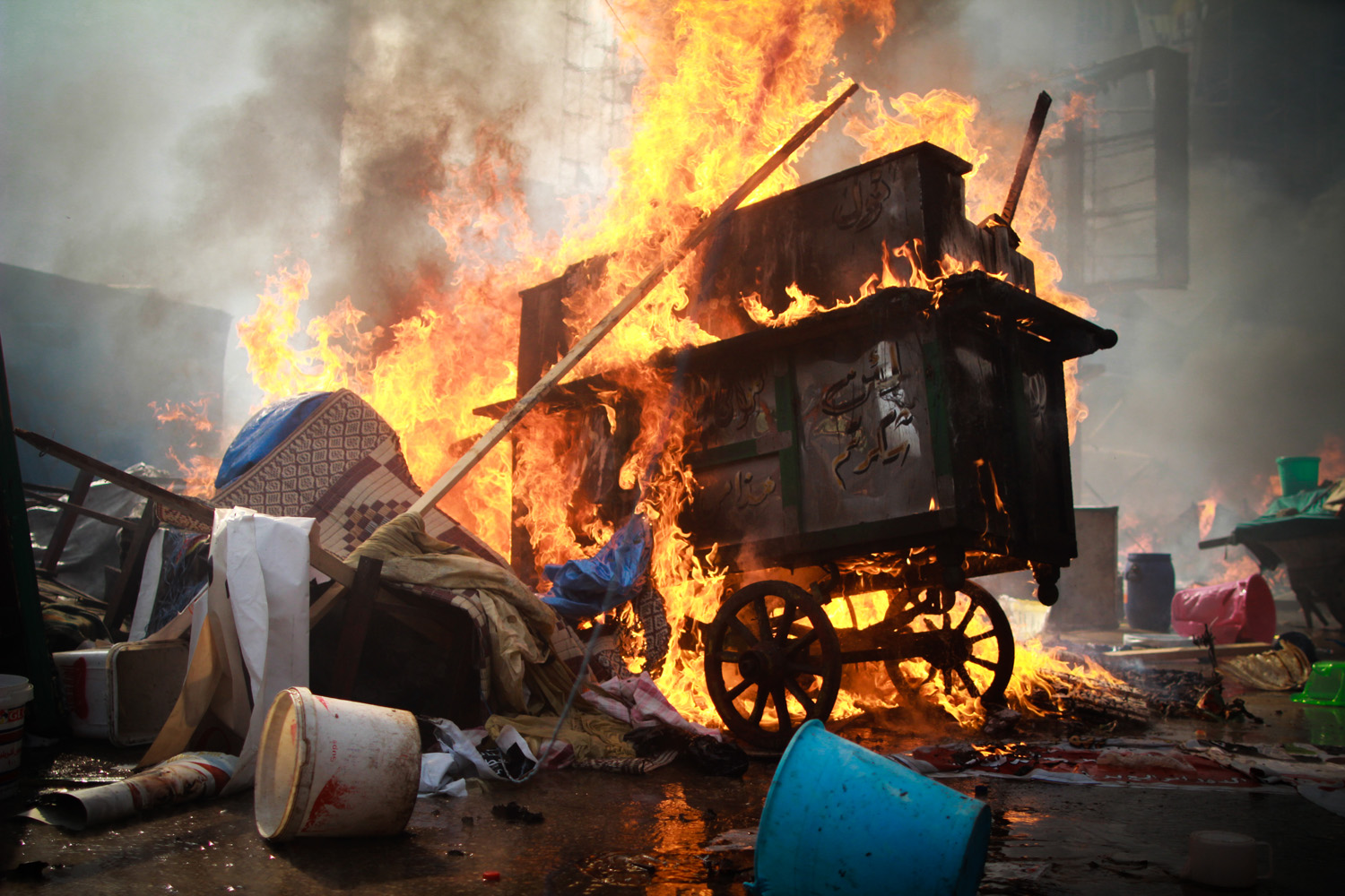 Aug. 14, 2013. A potato wheel-cart burns, along with tents and Morsi supporters' belongings as security forces violently dispersed the 40-day long Rabaa Adaweya sit-in.