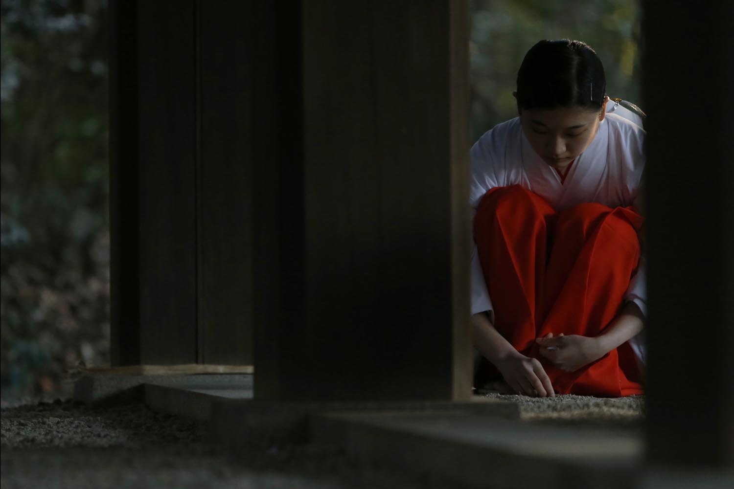 A shrine attendant cleans up after a ritual to bid farewell to 2013 and prepare for the new year at the Meiji Shrine in Tokyo