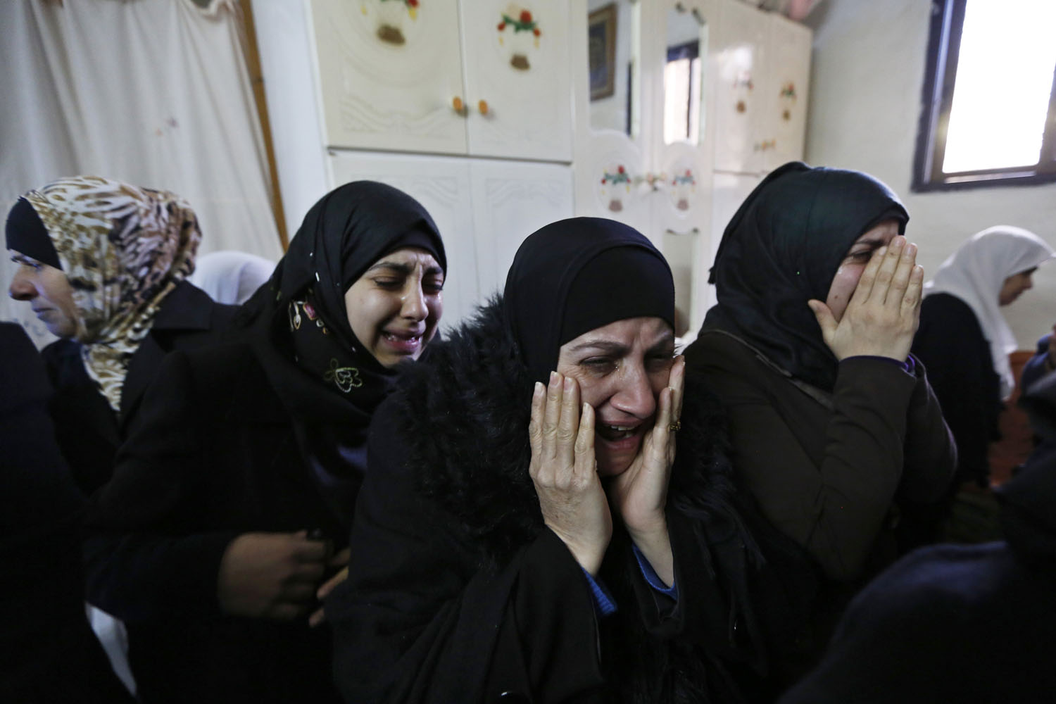 Jan. 2, 2014. Relatives mourn before the funeral of Palestinian Saeed Jaser Ali, 85, in the West Bank village of Kufr Kadum near Nablus. Ali died after inhaling tear gas fired by the Israeli army to disperse protesters in the occupied West Bank, witnesses said.