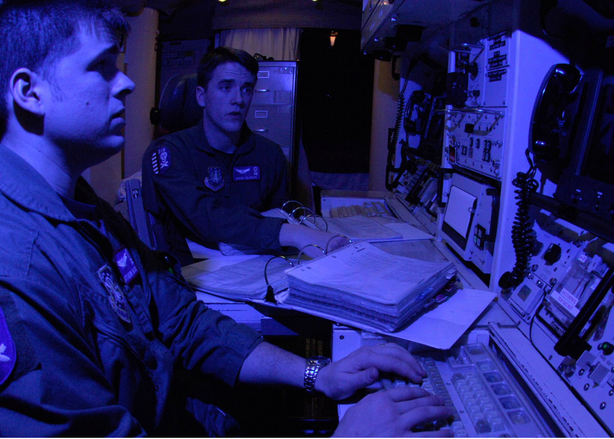 A pair of Air Force missile launch control officers, having passed their monthly proficiency tests, pull alert at a Minuteman III missile site.