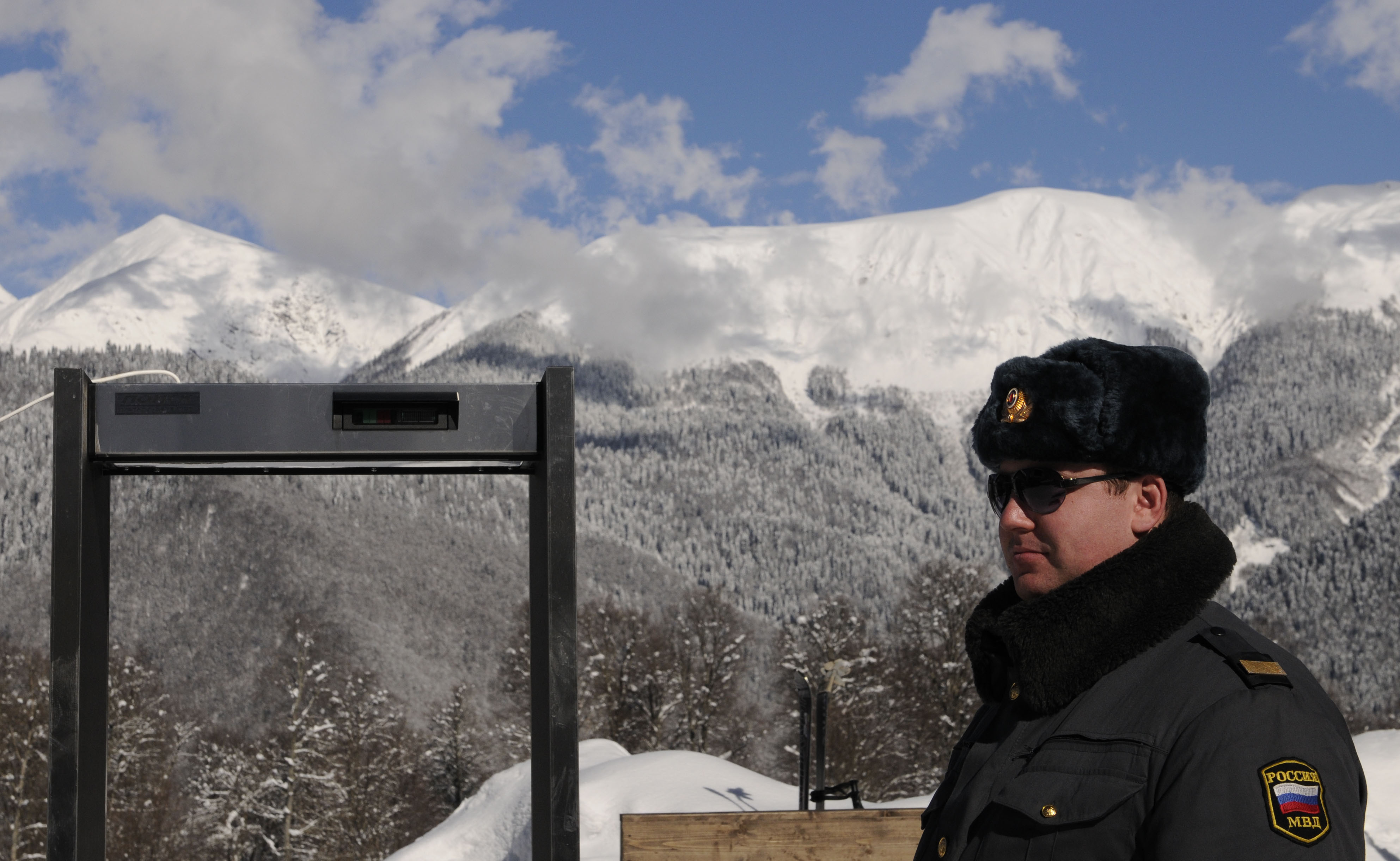 A police officer stands near a metal detector at the Mountain Carousel sports and holiday complex, near the Winter Olympics city of Sochi (Mikhail Mordasov / AFP / Getty Images)