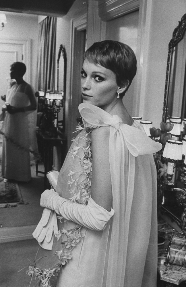 At the Sinatras' Grosvenor Square residence in London (other addresses: Paris, Palm Springs, Los Angeles, New York, Miami and Las Vegas), Mia Farrow preens in Cardin original before gala premiere of 'Taming of the Shrew.'