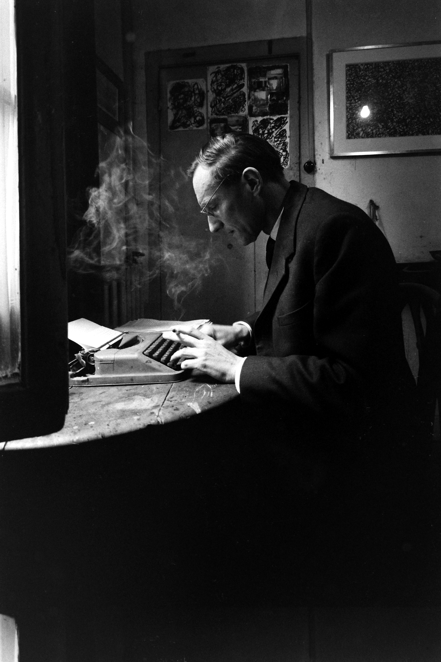 William S. Burroughs at his typewriter, Paris, 1959.
