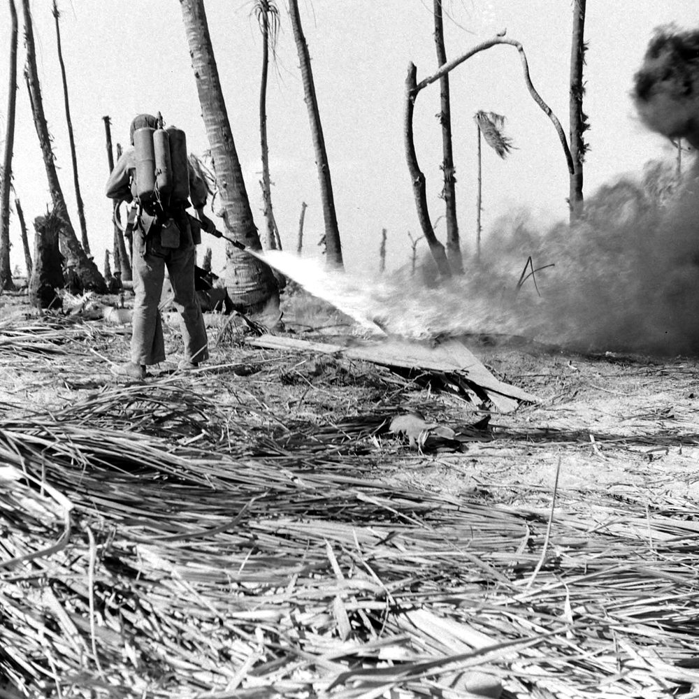 American Marines use a flamethrower on a Japanese pillbox during Battle of Eniwetok, February 1944.