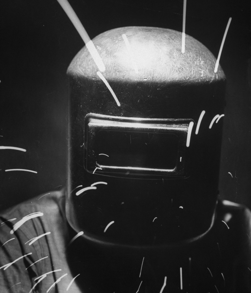 A man in a welder's helmet.