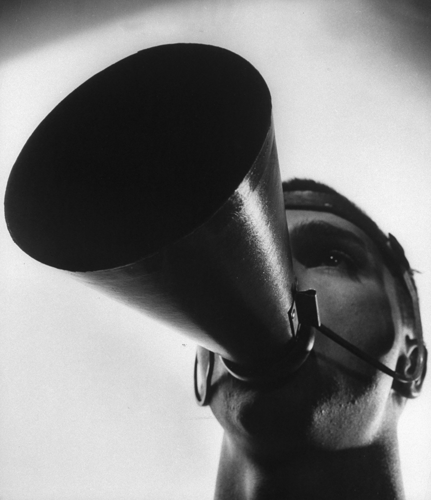 Closeup of a man wearing a megaphone.